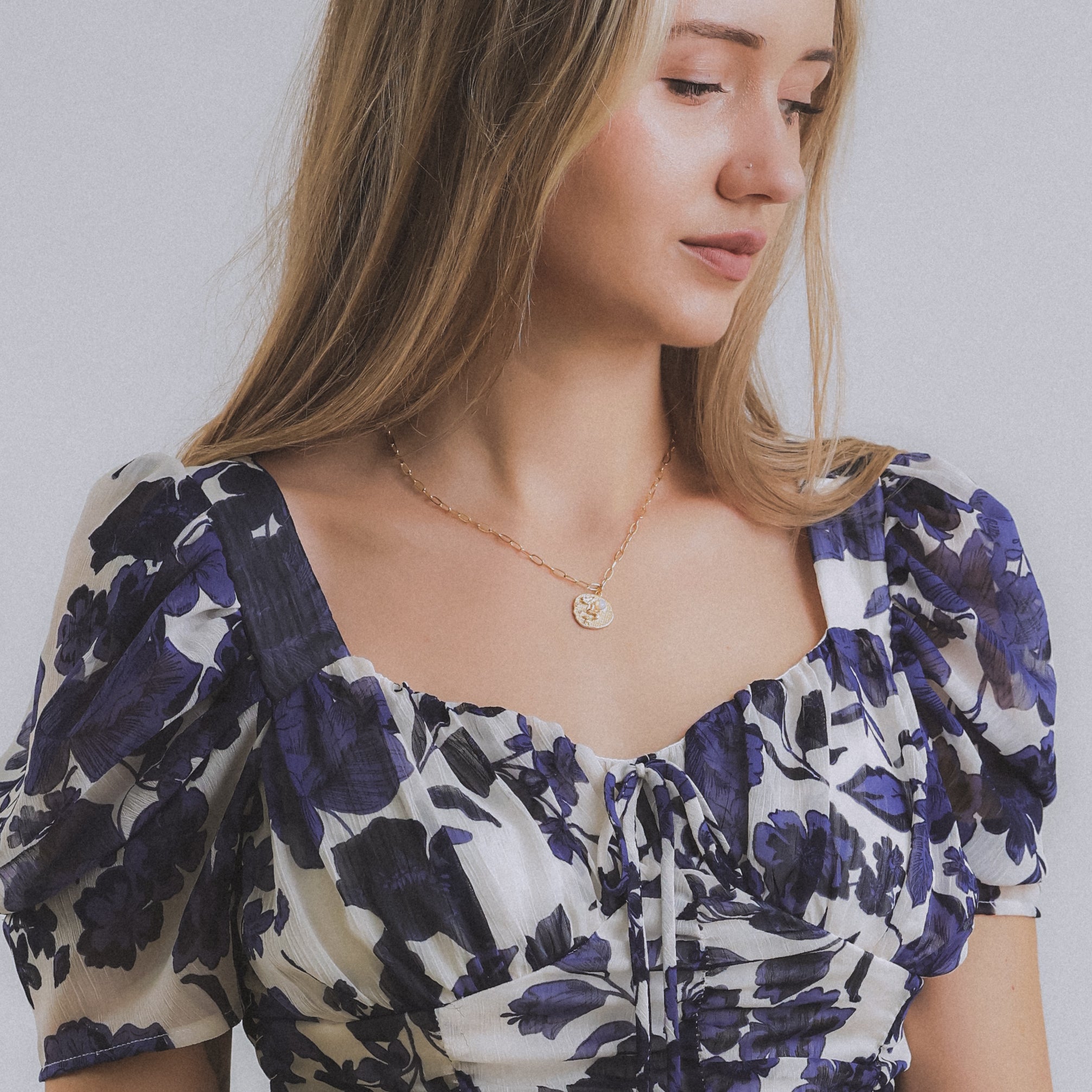 model displaying gold-filled and gemstone mermaid and opal charm necklace