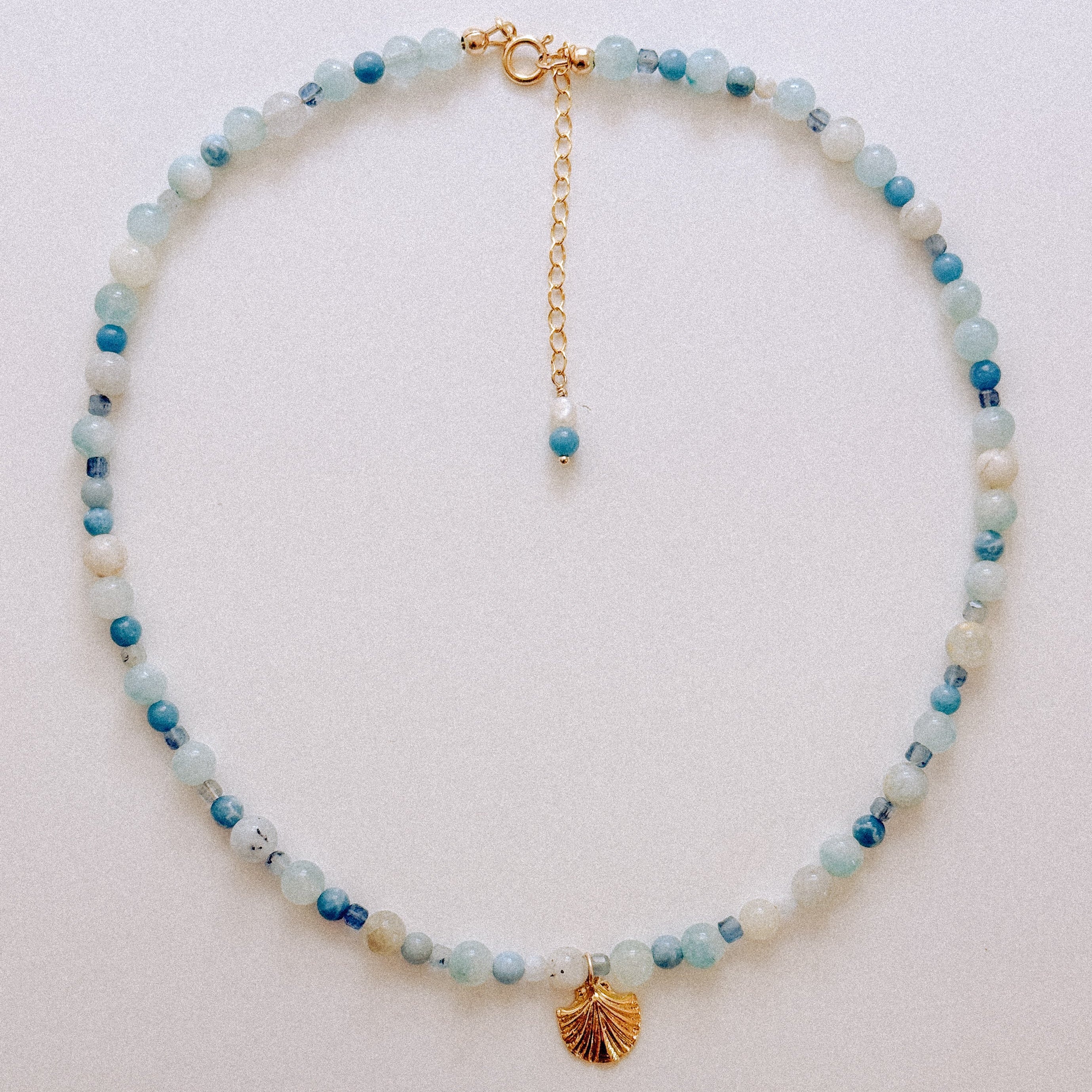Sand + Salt Studio / close-up of woman's neck wearing necklaces from Sand and Salt Studio collections