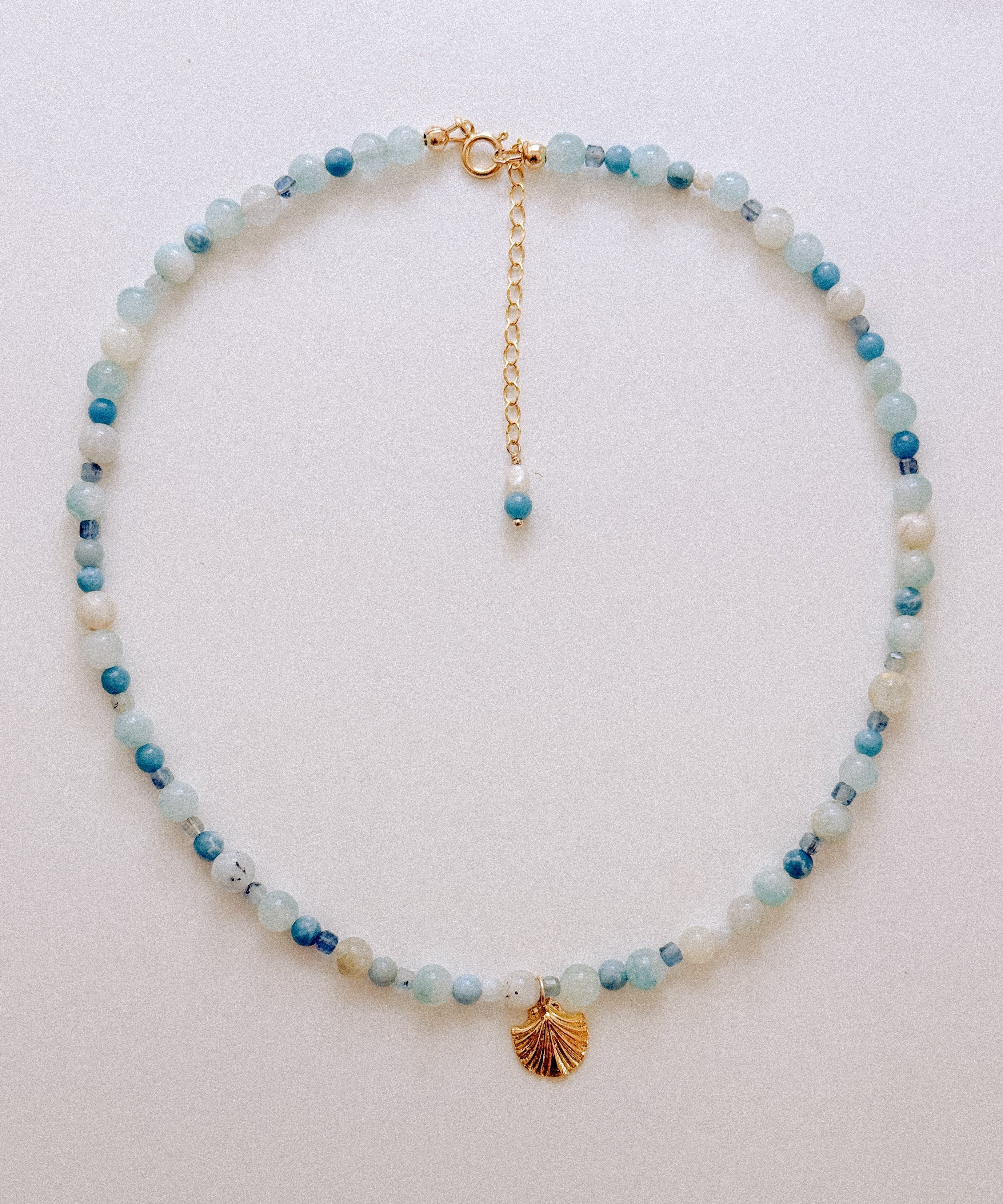 Sand + Salt Studio / close-up of woman's neck wearing necklaces from Sand and Salt Studio collections
