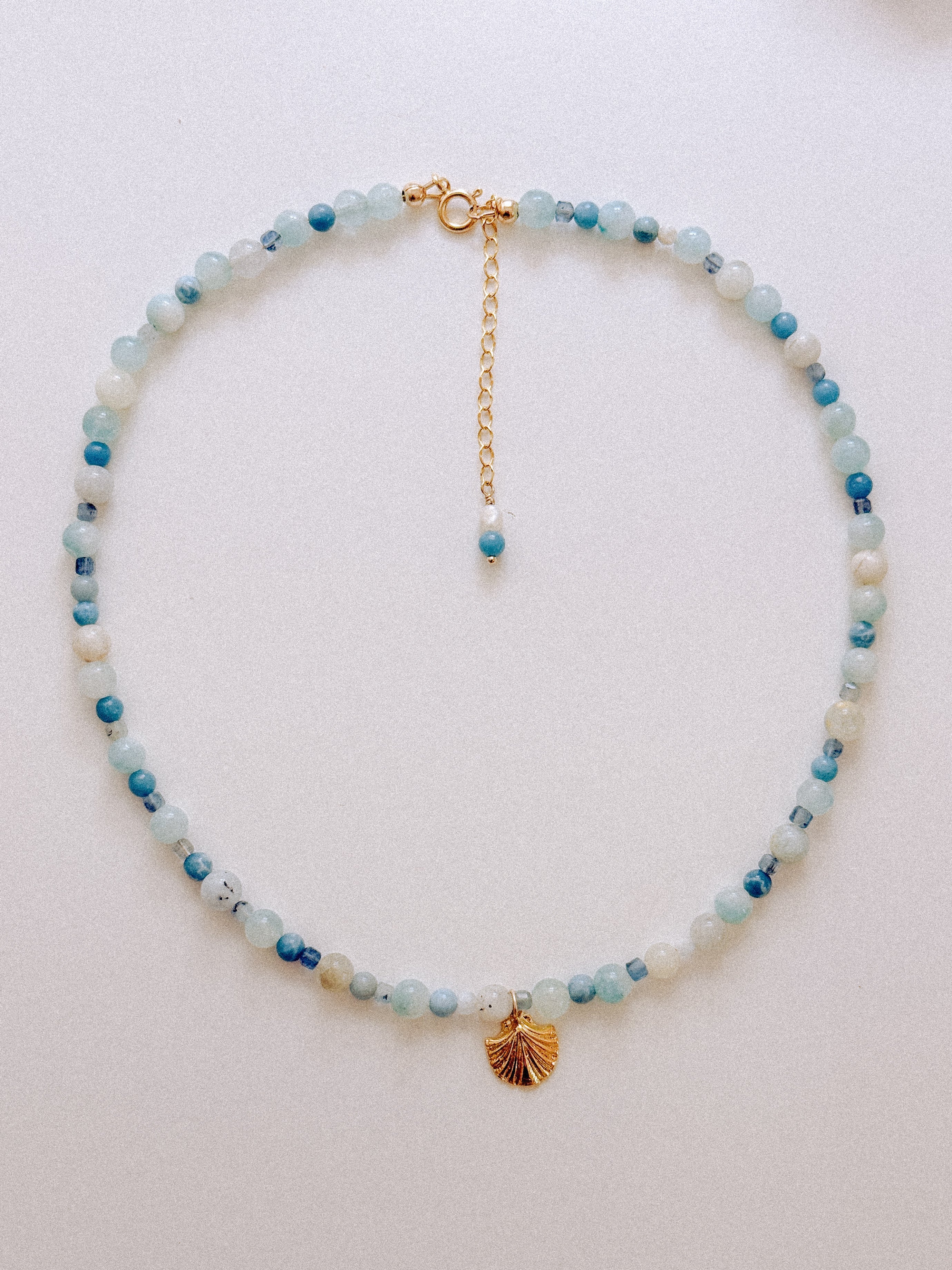 Sand + Salt Studio / close-up of woman's neck wearing necklaces from Sand and Salt Studio collections