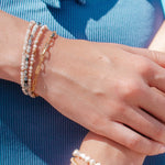 close-up of womans wrists, showing Sand + Salt's various bracelets, Sand and Salt Studio