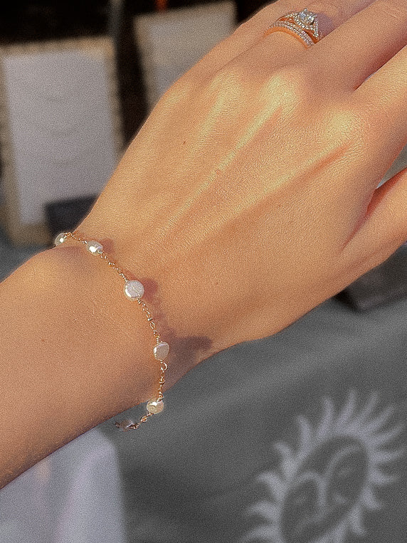 pearlfect bracelet modeled on wrist; sand + salt gold filled and freshwater pearl jewelry