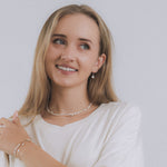 model wearing sand + salt jewelry; gold-filled, gemstone, and freshwater pearl jewelry