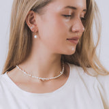 model wearing sand + salt jewelry; gold-filled, gemstone, and freshwater pearl jewelry