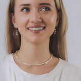 model wearing sand + salt jewelry; gold-filled, gemstone, and freshwater pearl jewelry