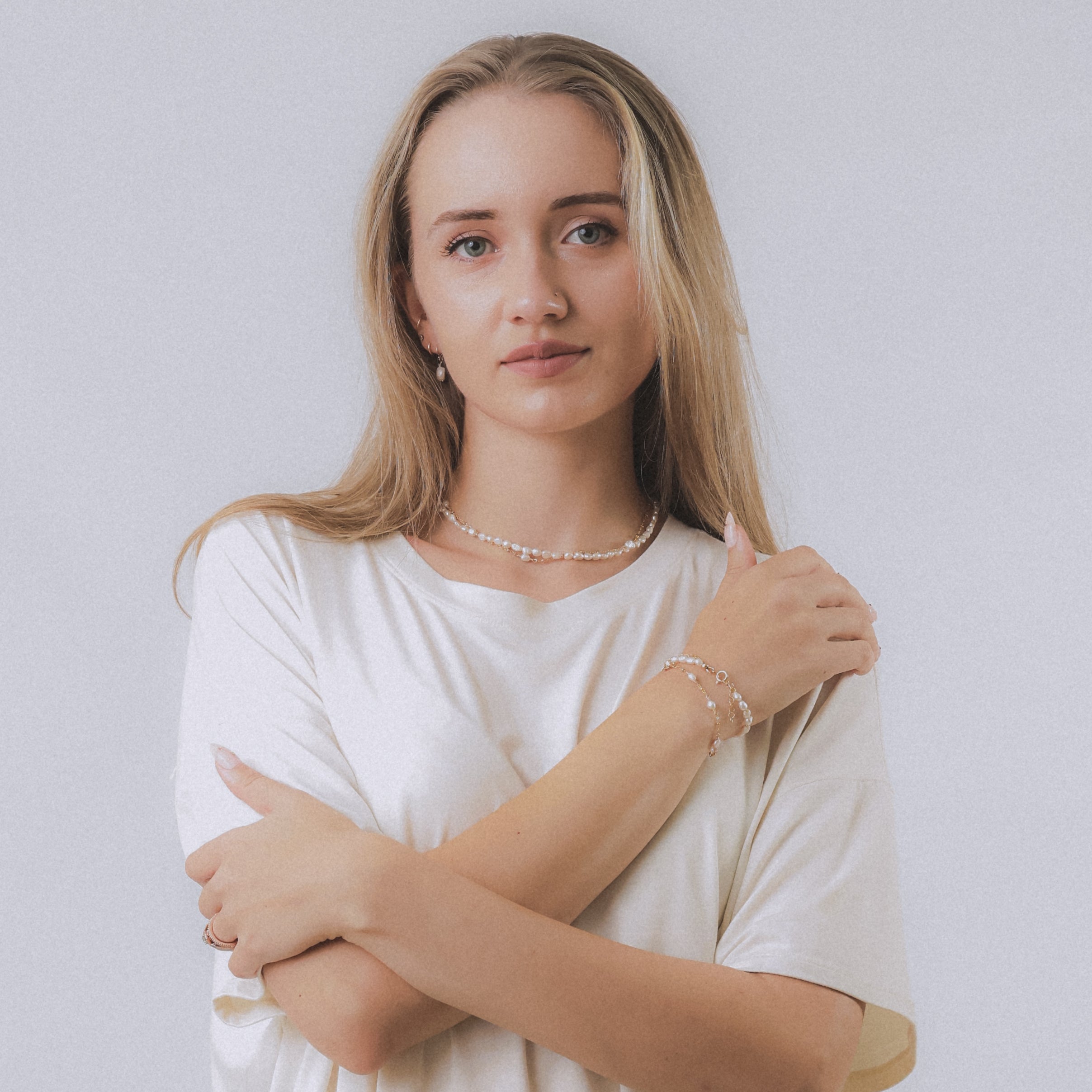 model wearing sand + salt jewelry; gold-filled, gemstone, and freshwater pearl jewelry