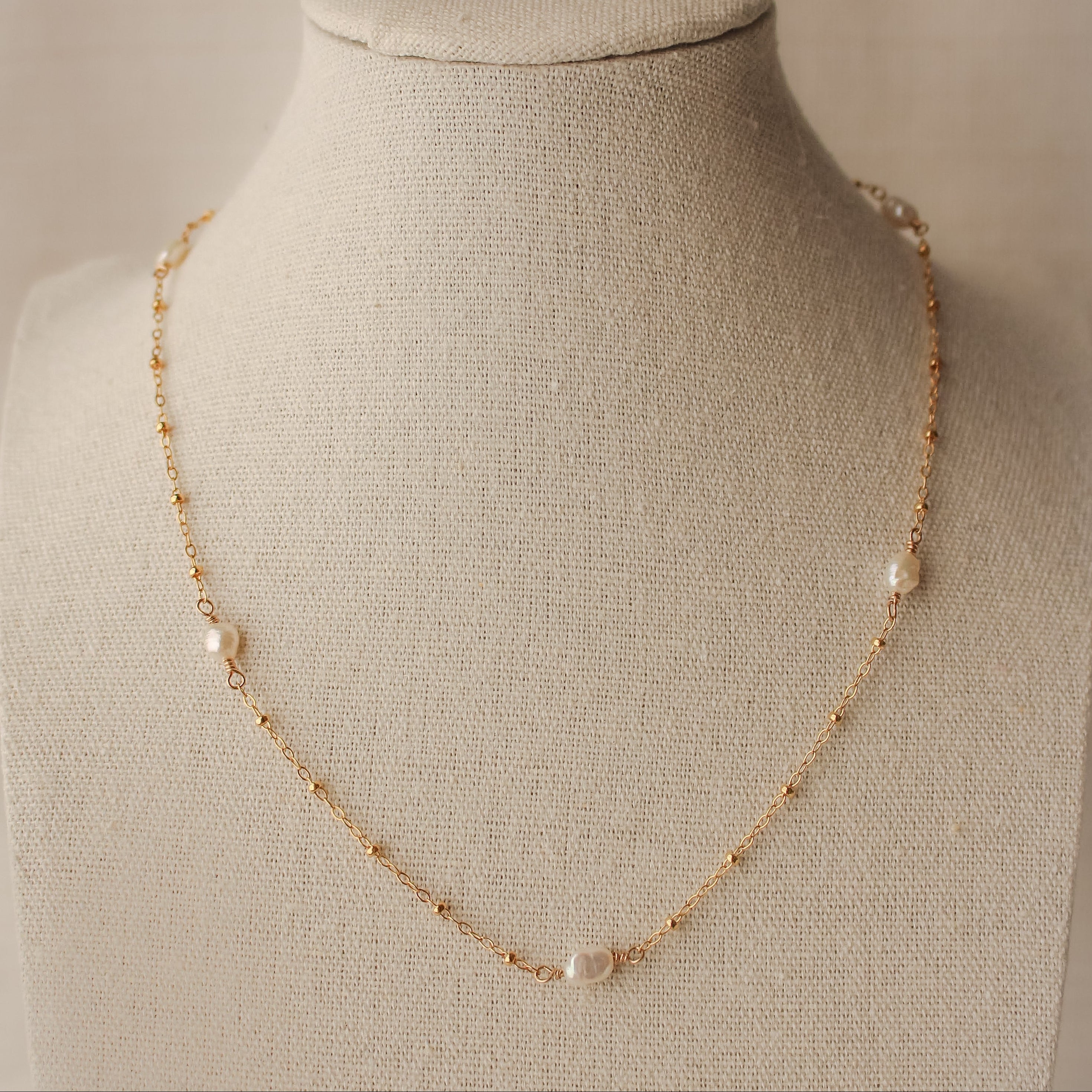 sand + salt pearlfect necklace on jewelry display bust, gold-filled and freshwater pearl necklace
